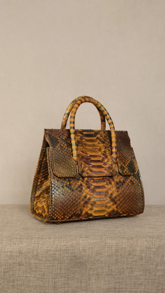 KYRA Adriana python exotic leather bag with unique handle design and sunglasses holder in a semi-classical silhouette