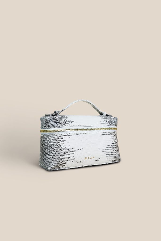 KYRA Picco 19 multifunctional bag in genuine natural lizard leather, sleek minimalist design, convertible from sling to clutch, luxury gold hardware for Eid 2026.