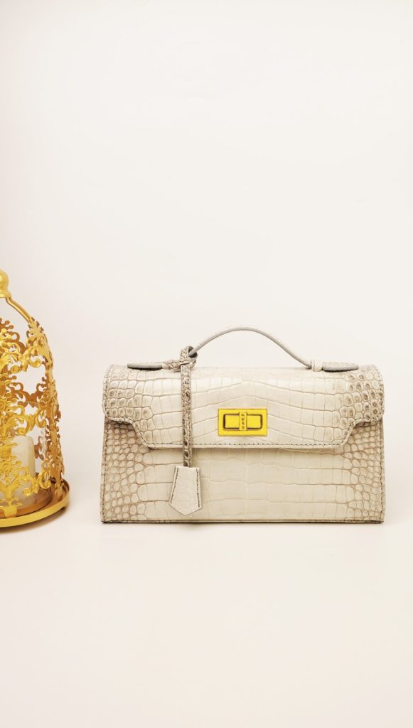 The Kyra Luna 29 in genuine crocodile leather, a versatile 3-way luxury business gift featuring a signature lock and contrast stitching for Eid 2026 in Doha.