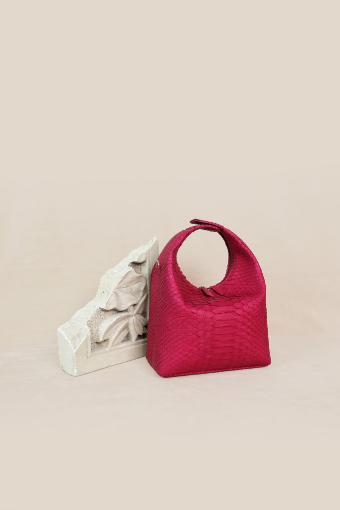 The KYRA OUNA mini hobo bag in genuine python leather, a versatile 4-way luxury business gift from the New Collection for Eid 2026 in Doha.