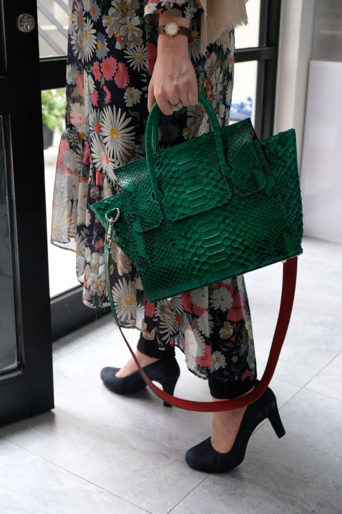 The KYRA Adriana in genuine python leather, featuring a unique back-side glasses holder and expandable wings, a perfect luxury business gift for Eid 2026.