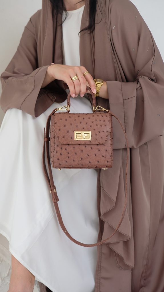 KYRA Luna Square Peanut Ostrich leather handbag featuring a smallest structured design with distinctive quill follicles and a strong top handle for timeless luxury styling.