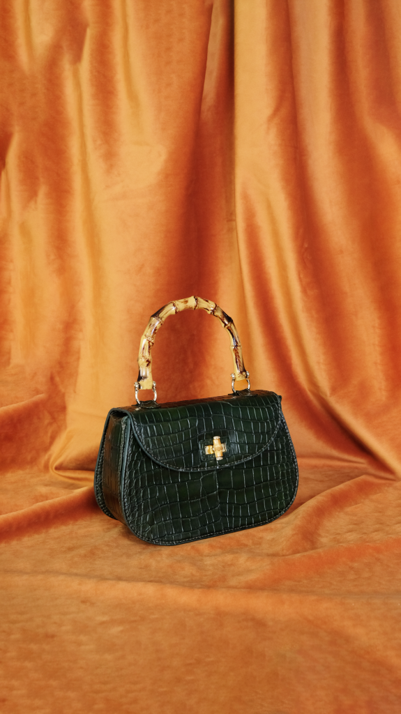 Hunter green customize bag in crocodile leather by KYRA, bamboo handle, gold turnlock closure.